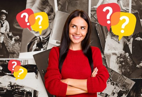 Barna, hosszú hajú nő piros pulóverben régi fényképek a háttérben