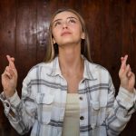 Fiatal nő keresztezi ujjait