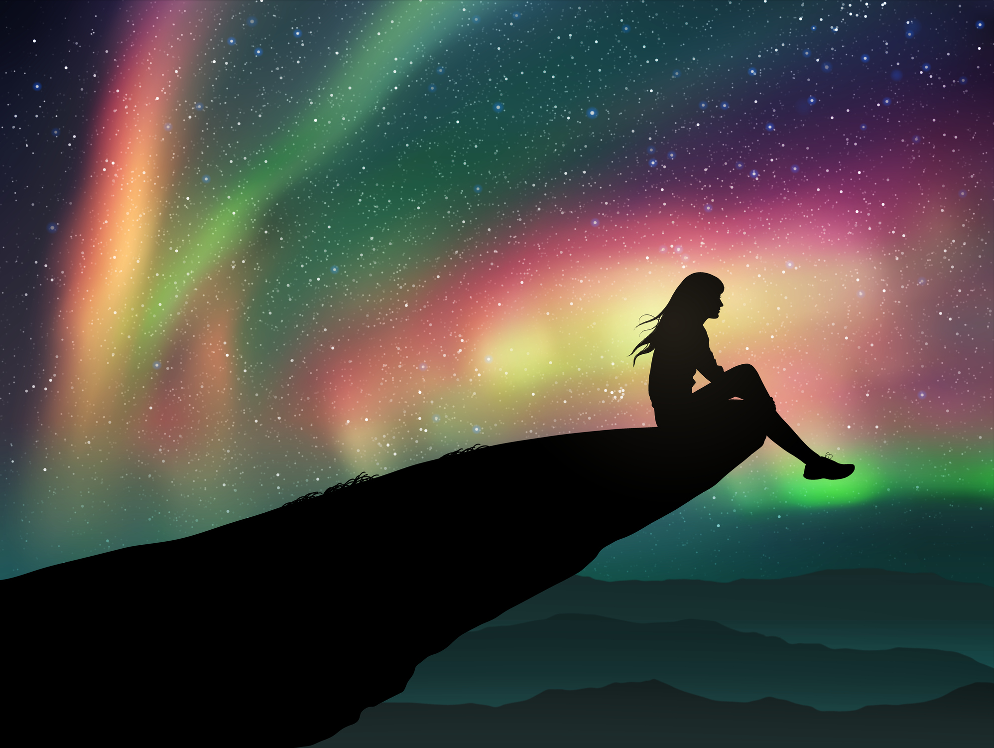 Egy nő ül egy sziklán, az ég színes