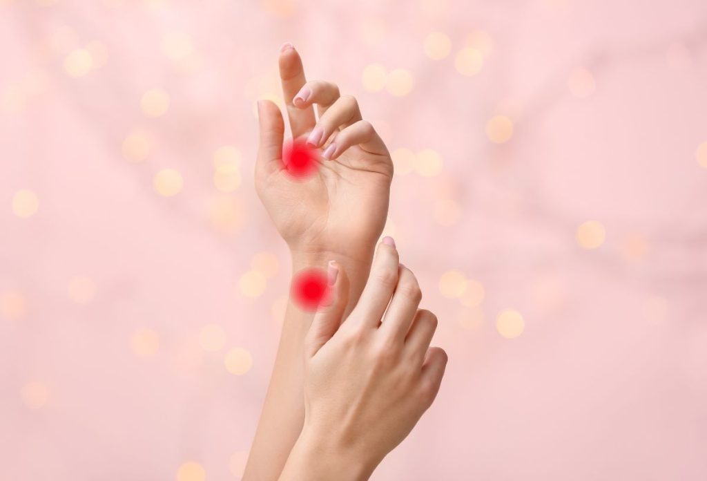 Rózsaszín háttér előtt női kezek, piros ponttal jelölve az orális szexet javító akupresszúrás pontok