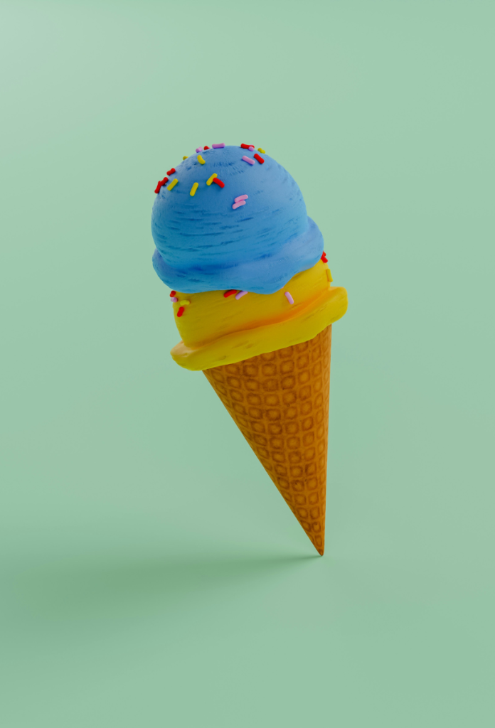 Mű hatású kék és sárga gombóc fagyi tölcsérben, mentazöld háttérrel