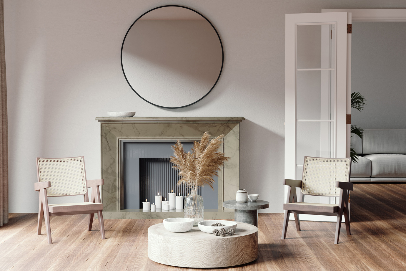 Régimódi fotelek dohányzóasztal és kandalló mellett egy nappaliban, ahol egy nagy kerek tükör is található