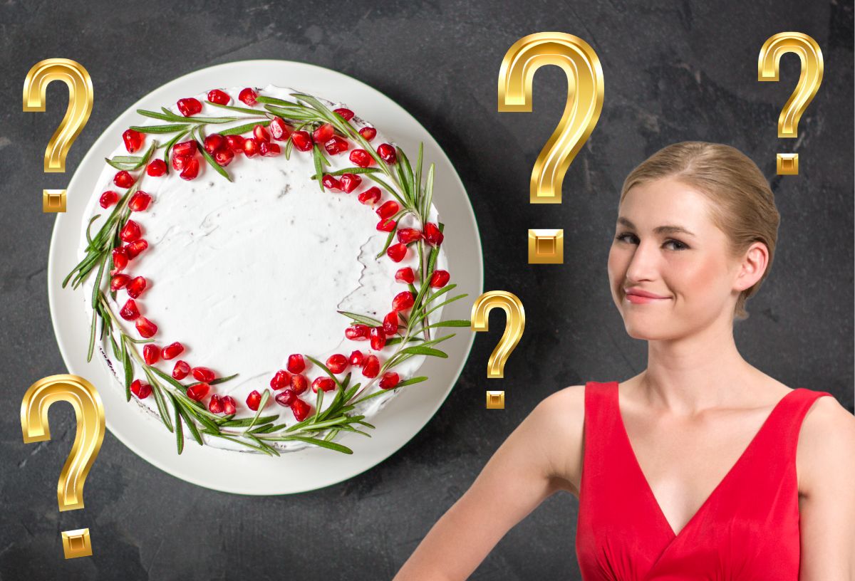 Piros ruhában vidám szőke fiatal nő, mellette karácsonyi sütemény, arany kérdőjelek