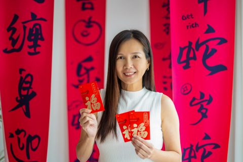 Kínai nő újévi kártyákat tart a kezében kínai újévkor