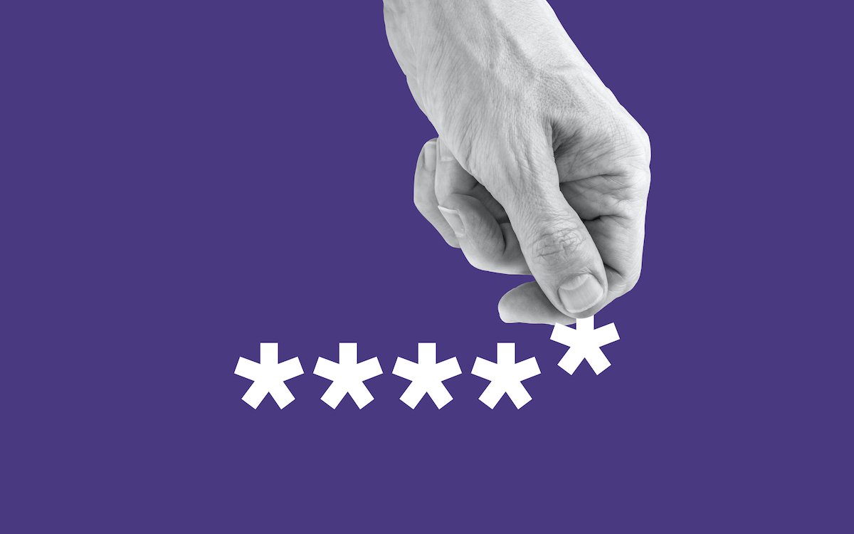 Emberi kéz, amely egy csillag karaktert tart egy jelszóból. Lila háttér