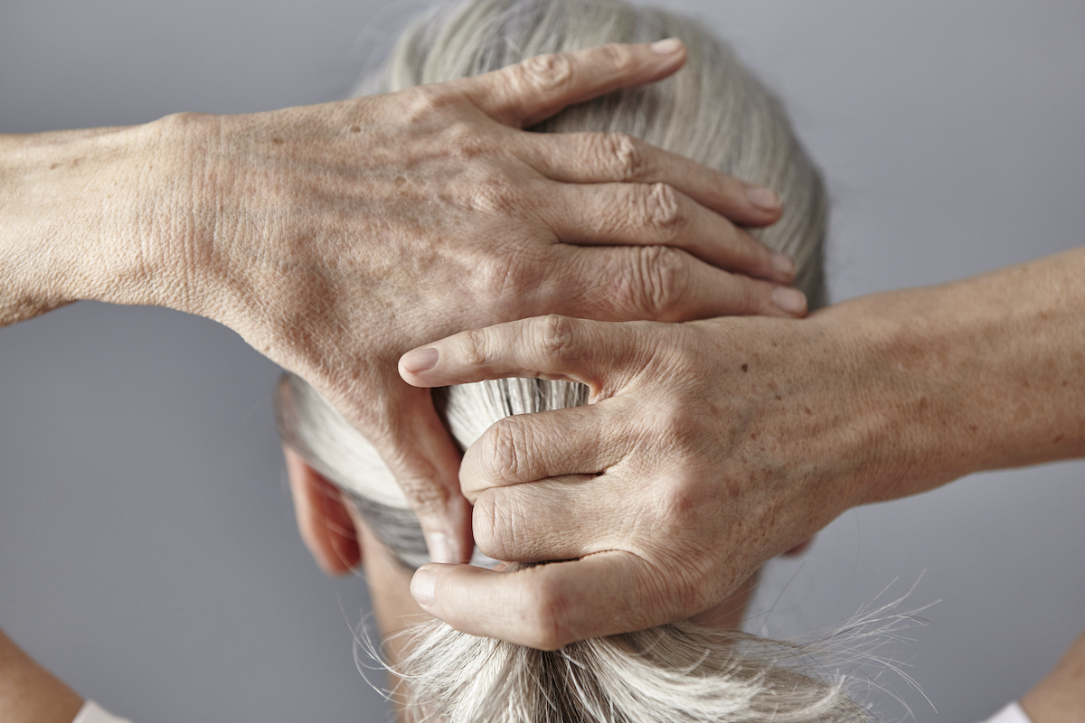 női fej háttal, ősz haját átfogja, lófarkat köt