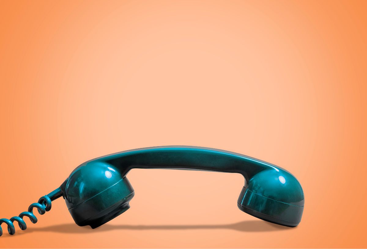 Narancsszínű háttér előtt türkizzöld telefonkagyló