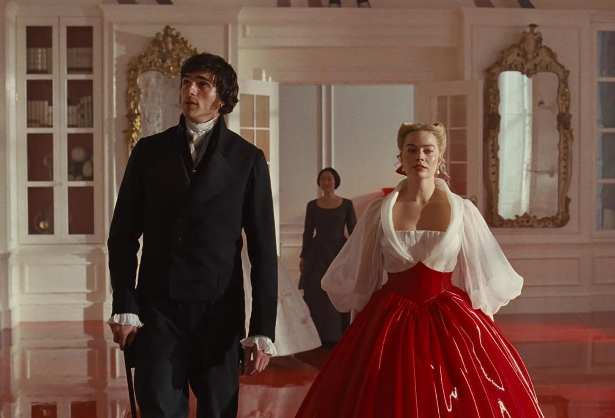 Jacob Elrodi és Margot Robbie az Üvöltő szelekben díszes terembe lépnek be elegáns ruhában