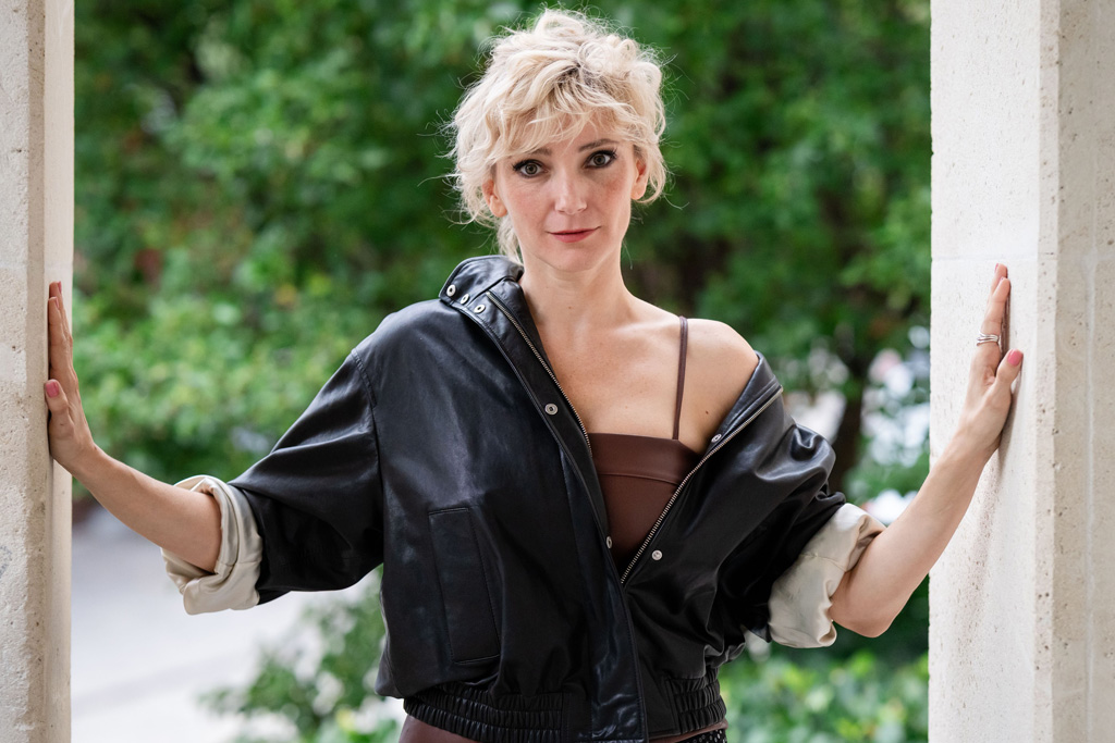 Borbély Alexandra komoly arccal néz, miközben a kétoldalt a falnak támaszkodik