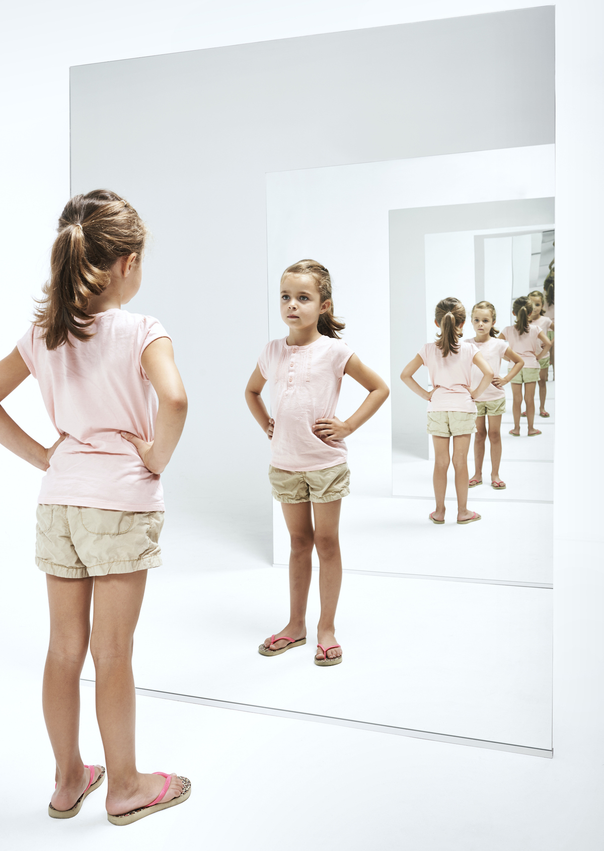 narcisztikus-gyerek-3-szuloi-hiba-okoknarcisztikus-gyerek-3-szuloi-hiba-okok | Marie Claire kislány rózsaszín pólóban, tükör előtt, sokszoros tükröződésben