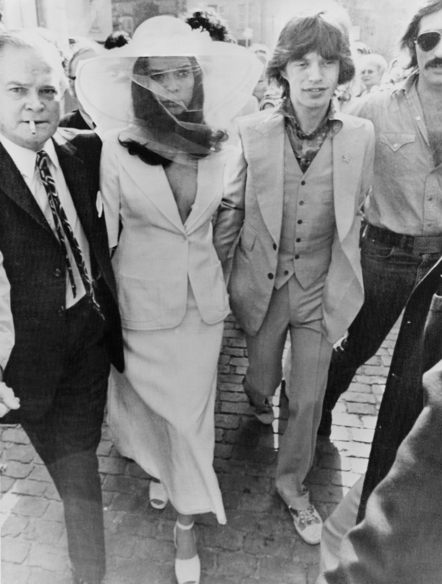 dua-lipa-menyasszonyi-ruha-uzenet | Marie Claire A fehér menyasszonyi ruhát viselő Bianca Jagger és Mick Jagger fekete-fehér esküvői fotója