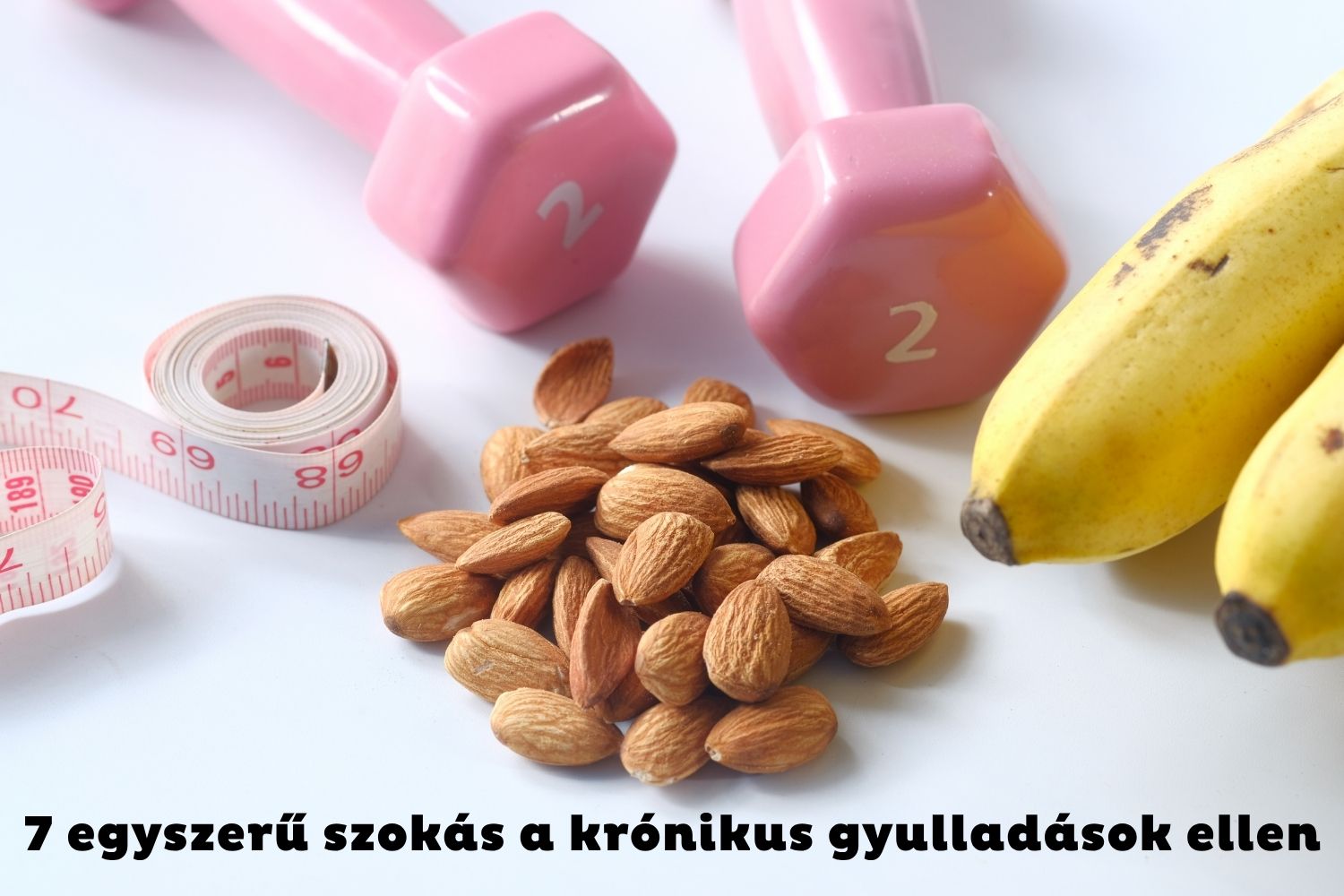 Mandula, rózsaszín kézisúlyzók, banán fehér háttéren
