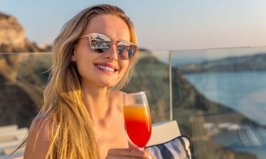 nyari-koktelozas-alkohol-hatasa-a-borre2 | Marie Claire Nő koktéllal, napszemüvegben a tengerparton