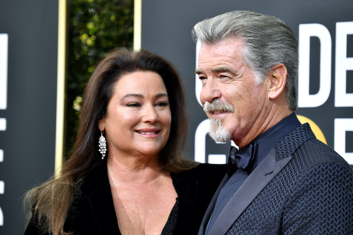 Keely Shaye Brosnan fekete ruhában, kiengedett hajjal és Pierce Brosnan szakállal – közelről