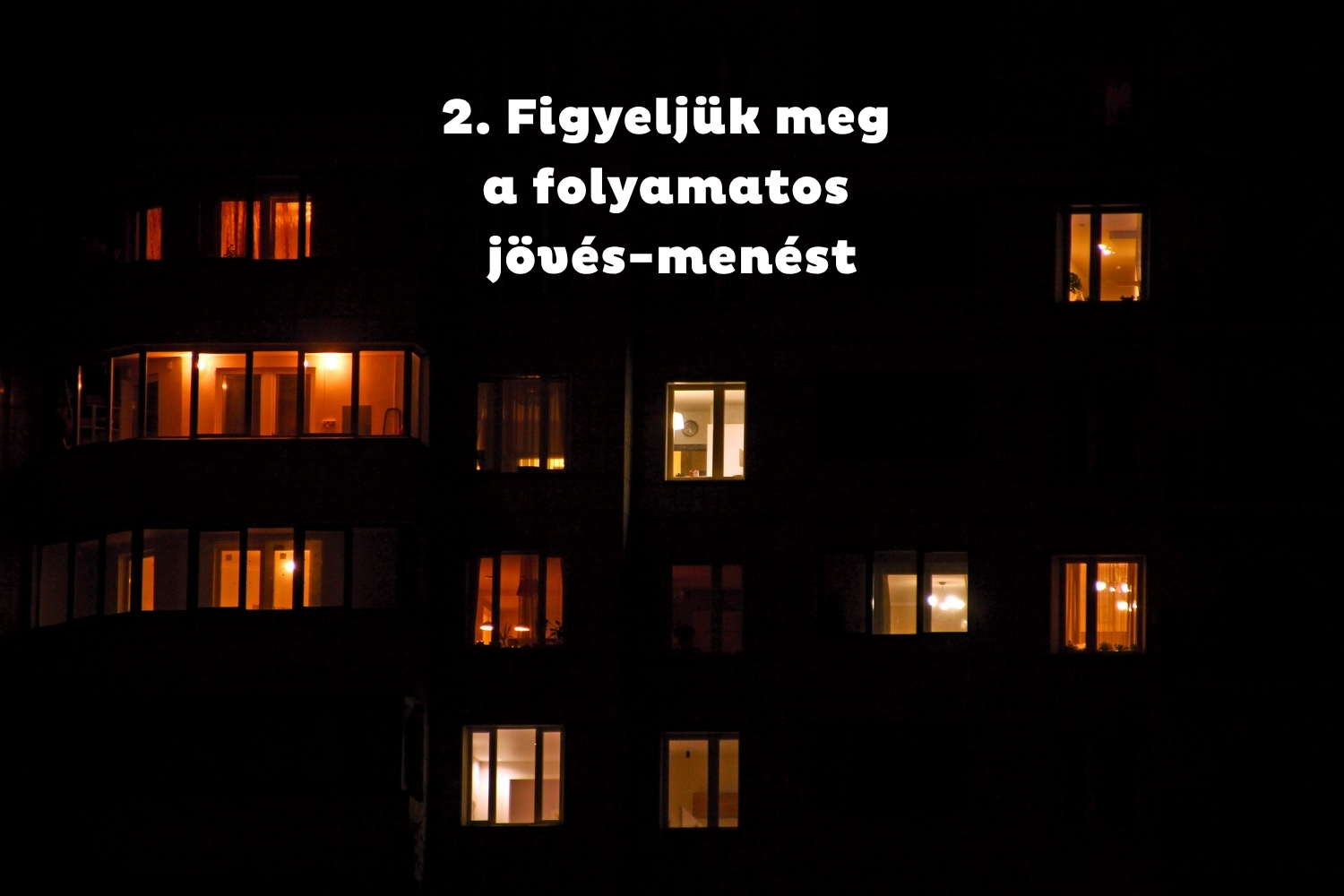 Társasház éjszaka, néhány ablak világít
